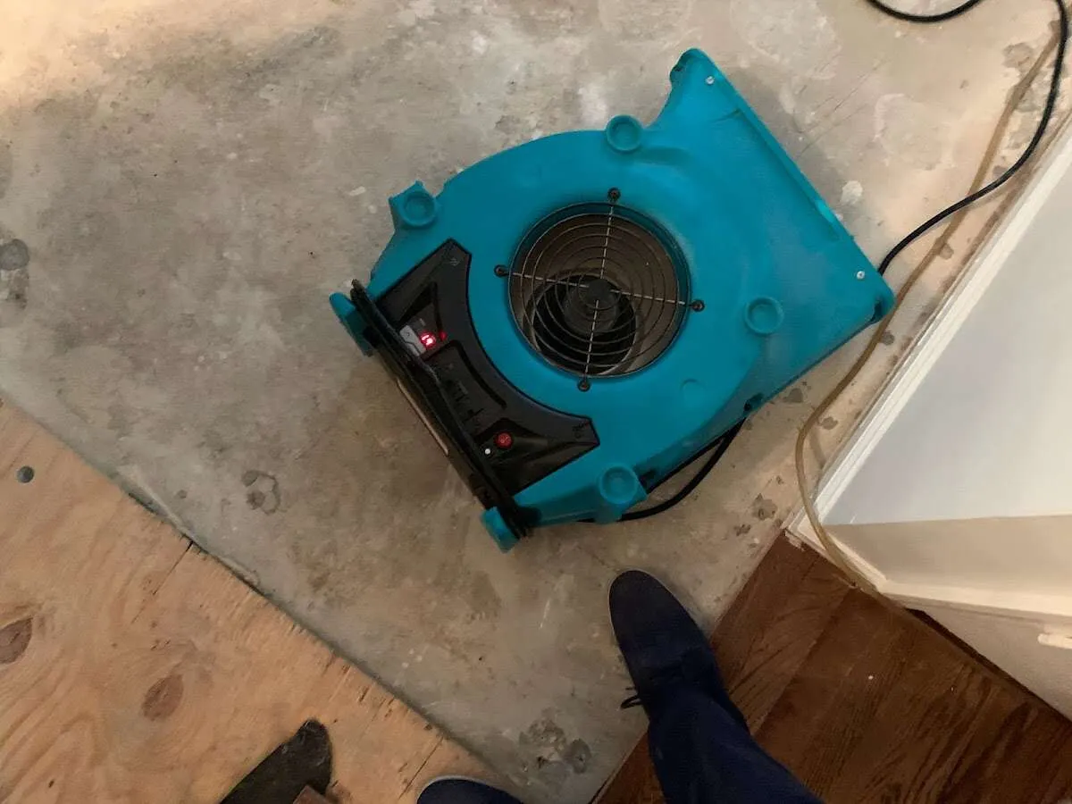 Air mover drying subfloor during Commercial Water Damage Restoration in Buffalo